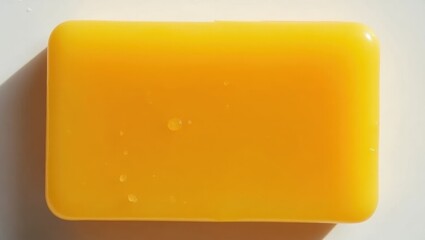 Turmeric Soap. Bright yellow soap bar with water droplets on smooth surface, cleaning product concept, hygiene advertisement, minimalistic white background, fresh and clean mood for skincare promotio