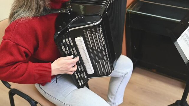 Accordion keys in sharp focus while a woman in red plays passionately. The contrast between black and white keys, combined with the musician's movements, captures the essence of artistic dedication