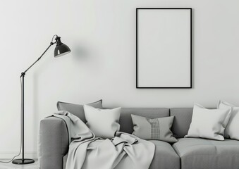 A minimalist living room with a gray couch. a black floor lamp. and a black framed picture hanging above the couch