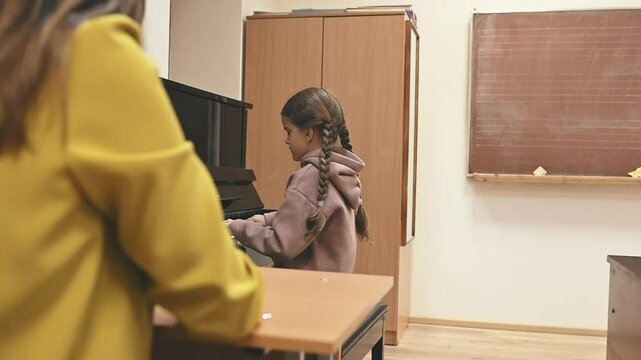 A young pianist improves musical hearing through focused practice, developing early auditory skills. Music training sharpens listening, refines coordination, and builds a strong connection with sound