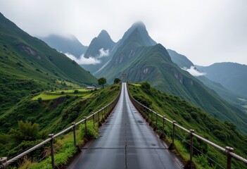 Suspension bridge leading to misty green mountains
