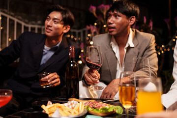 Celebrate whiskey at a friendly party in a restaurant. Night.