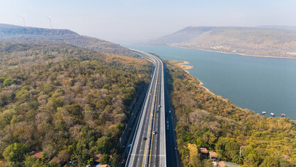 Fototapeta premium Drone shot aerial view landscape of the M6 motorway Expressway Nakhon Ratchasima Province - Bang Pa-in. Lam Ta Khong River and Mountain. Drone shot of scenic landscape rural place traffic