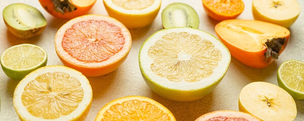 A close up of various citrus fruits including oranges, grapefruit, and kiwi. Concept of abundance and variety, showcasing the different colors and shapes of the fruits