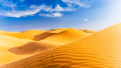 Panoramic view of desert in Liwa against blue sky
