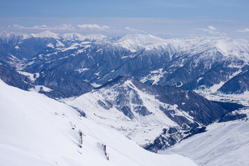 Majestic Winter Panorama of Snow-Capped Mountains Capturing the Serenity and Grandeur of Nature's Untamed Beauty in a Crisp Blue Sky