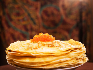lots of delicious, mouth-watering pancakes with red caviar for Russian Maslenitsa.