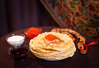 lots of delicious, mouth-watering pancakes with red caviar for Russian Maslenitsa.