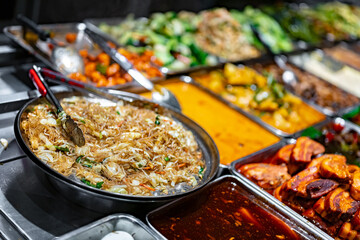 Traditional Asian dishes sold in a food court in Singapore