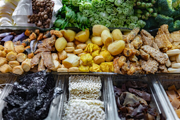 Traditional Asian dishes sold in a food court in Singapore