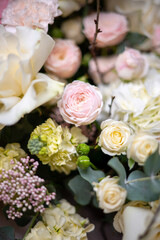 Delicate composition of white and pink roses in a basket