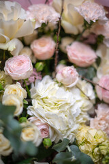 Delicate composition of white and pink roses in a basket
