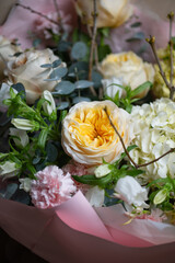 Delicate composition of white and pink roses in a basket