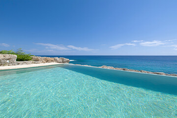 Fototapeta premium Global wellness tourism. Luxurious infinity pool overlooking serene ocean and clear blue sky