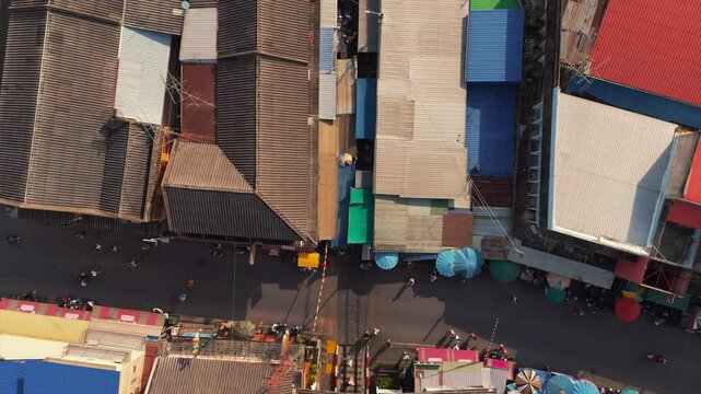 Vibrant local business scene at Maeklong Railway Market, a cultural experience with a moving train.