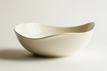 Elegant curved white ceramic bowl displayed on a neutral background showcasing its minimalist design and smooth texture