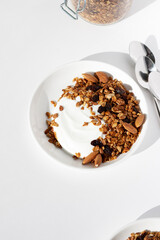 Breakfast Preparation. Greek Yoghurt, Granola with Walnuts, Sunflower Seeds, Raisins. 