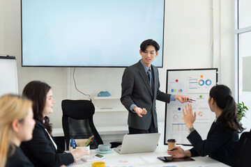 Dynamic business presentation with a diverse team discussing financial strategies in a modern office setting.