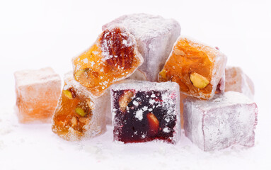 Sweet food Turkish delight, assorted rahat locum in form of cubes with nuts and powdered sugar, traditional food, on white background