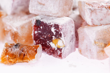 Sweet food Turkish delight, assorted rahat locum in form of cubes with nuts and powdered sugar, traditional food, on white background