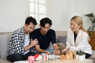Real estate agents discussing property options with clients at home.