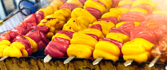 Fresh Red and Yellow Bell Peppers on Skewers, Ready for Grilling in the Backyard