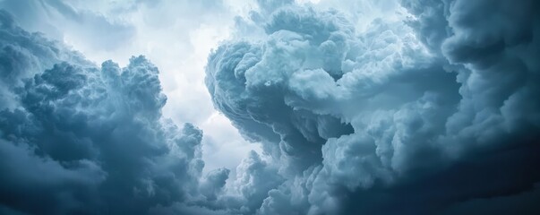 Science meteorology education concept. Dramatic blue clouds with light peeking through a stormy sky.