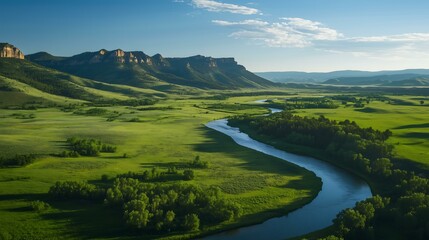 Obraz premium Breathtaking aerial view of a tranquil river winding through lush green hills.