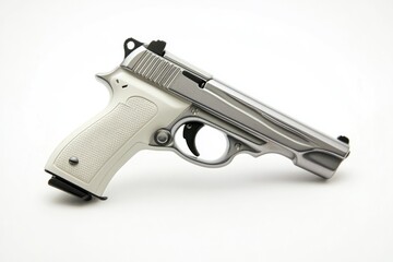 A silver gun lying on a clean white surface, ready for use