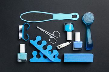 Set of pedicure tools on black background, flat lay