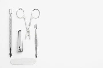 Set of pedicure tools on light background, flat lay. Space for text