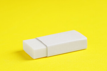 One eraser on yellow background, closeup view