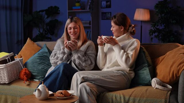 Girlfriends Enjoying a Cozy Evening of Knitting and Creativity on a Soft Couch