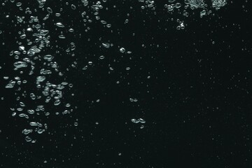 Many water bubbles on black background, closeup