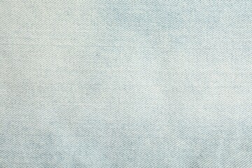 Texture of light blue jeans as background, closeup