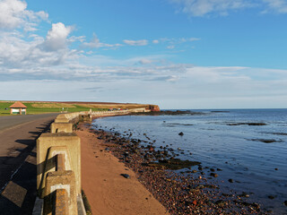 Kings Drive at Victoria Park in Arbroath, with the tide coming in and the exposed rocks just visible on a sunny day in February.
