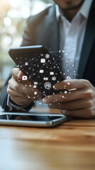 Fototapeta premium Businessman using a mobile phone with digital icons on the screen 