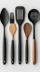 A set of shiny silver kitchen utensils, including a fork, knife, and spoon, isolated on a white background
