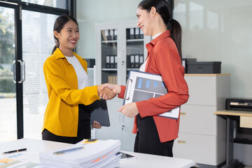 Businesswoman shake hands after agreeing to start a new project successfully.