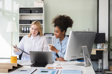 Diverse professionals collaborate on project analysis with financial graphs.