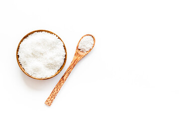 Plakat Coarse sea salt in a wooden and spoon, top view. Salt for spa, salt baths or cooking