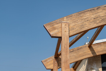 glulam with signs of wear due to time and weather. structure with arched beams and supporting pillars. commercial building designed with structural exposed modules. project, glued laminated timber