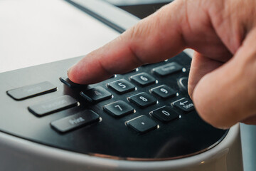 close up of finger pressing button to entering data on body composition analyzer