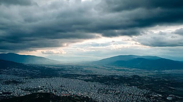 Aerial view of Karditsa city in Greece under a dramatic cloudy sky at dusk, Aerial view of the city Karditsa in Greece on a cloudy day in afternoon