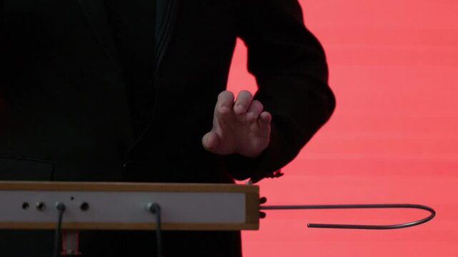 Playing the theremin. The theremin, etherphone, thereminophone or termenvox, thereminvox, is an electronic musical instrument controlled without physical contact by the performer. Patented in 1928