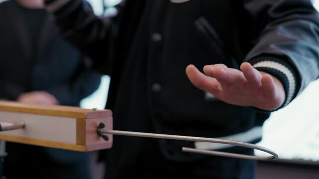 Playing the theremin. The theremin, etherphone, thereminophone or termenvox, thereminvox, is an electronic musical instrument controlled without physical contact by the performer. Patented in 1928