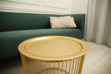 Stylish coffee table near sofa in living room
