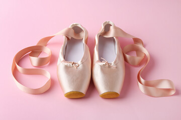 Pair of beautiful pointe shoes on pink background © New Africa