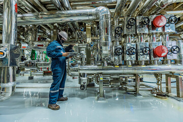 Male work inspection process stainless steel tanks and pipe with pressure meter in equipment tank...