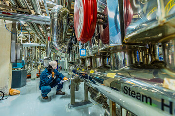 Male work inspection process stainless steel tanks and pipe with pressure meter in equipment tank facility